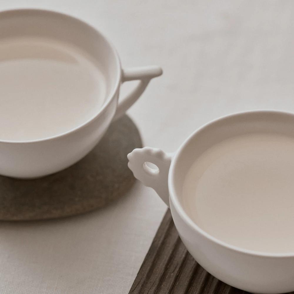 White Porcelain Cups Set with Ram Pattern Display